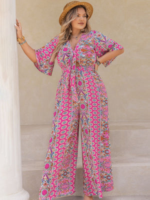 Bohemian tie-front palazzo jumpsuit in pink with a vibrant paisley print and bell sleeves.