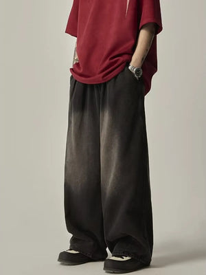 Relaxed fit black vintage wash drawstring jeans with a faded effect.