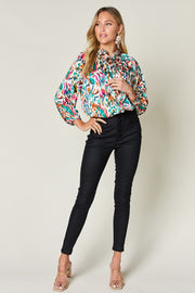 Silk Ikat Tie-Neck Blouse with abstract print and button closure.
