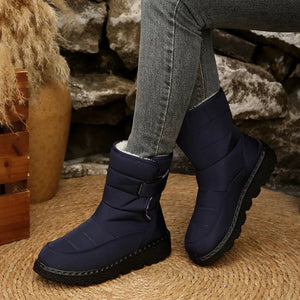 Blue quilted round toe platform boots with adjustable strap and plush lining.