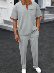 Gray textured polo shirt with contrast collar and pocket, paired with matching track pants.