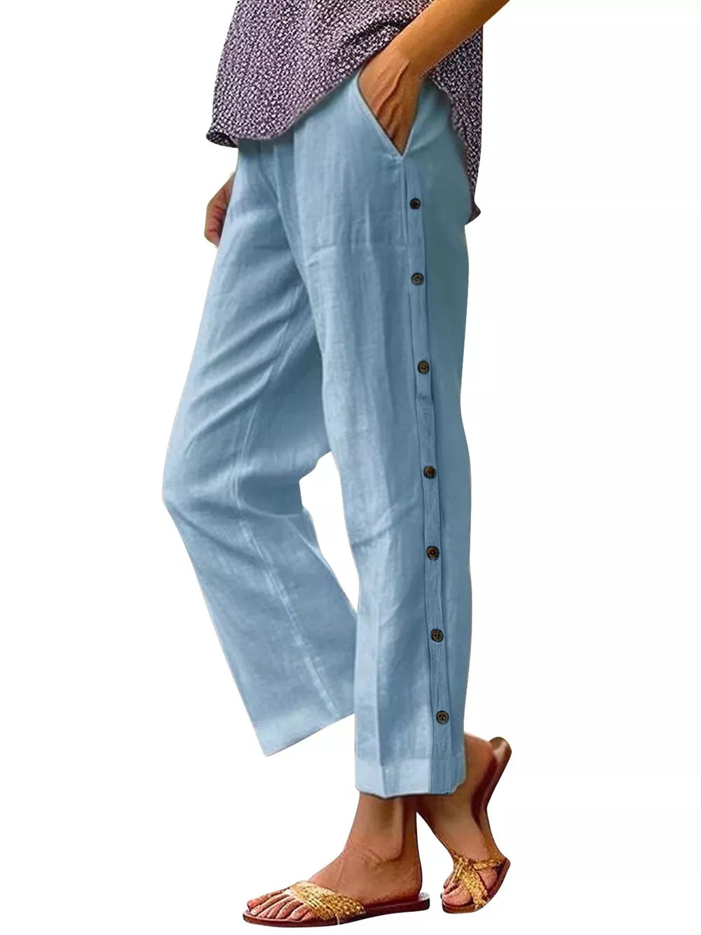 Sky blue relaxed fit pants with decorative side buttons and pockets.
