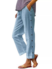 Sky blue relaxed fit pants with decorative side buttons and pockets.