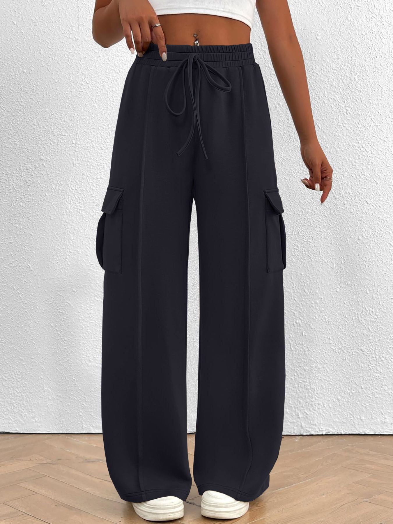 Navy high waist cargo sweatpants with drawstring and side pockets.