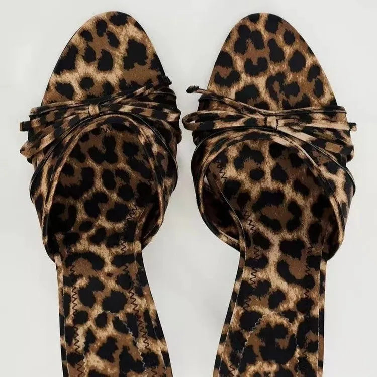 Leopard print knot heel mules with a pointed toe and knotted strap detail.