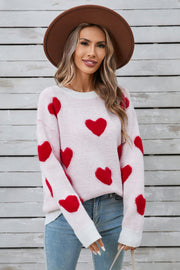 White crewneck sweater with red heart appliqué, long sleeves, casual knit style