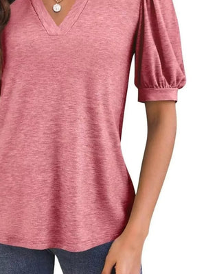 Rose pink t-shirt with notched V-neck and short puff sleeves.