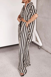 White and black vertical stripe lounge set with cutout top and wide leg pants.