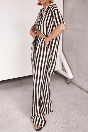 White and black vertical stripe lounge set with cutout top and wide leg pants.