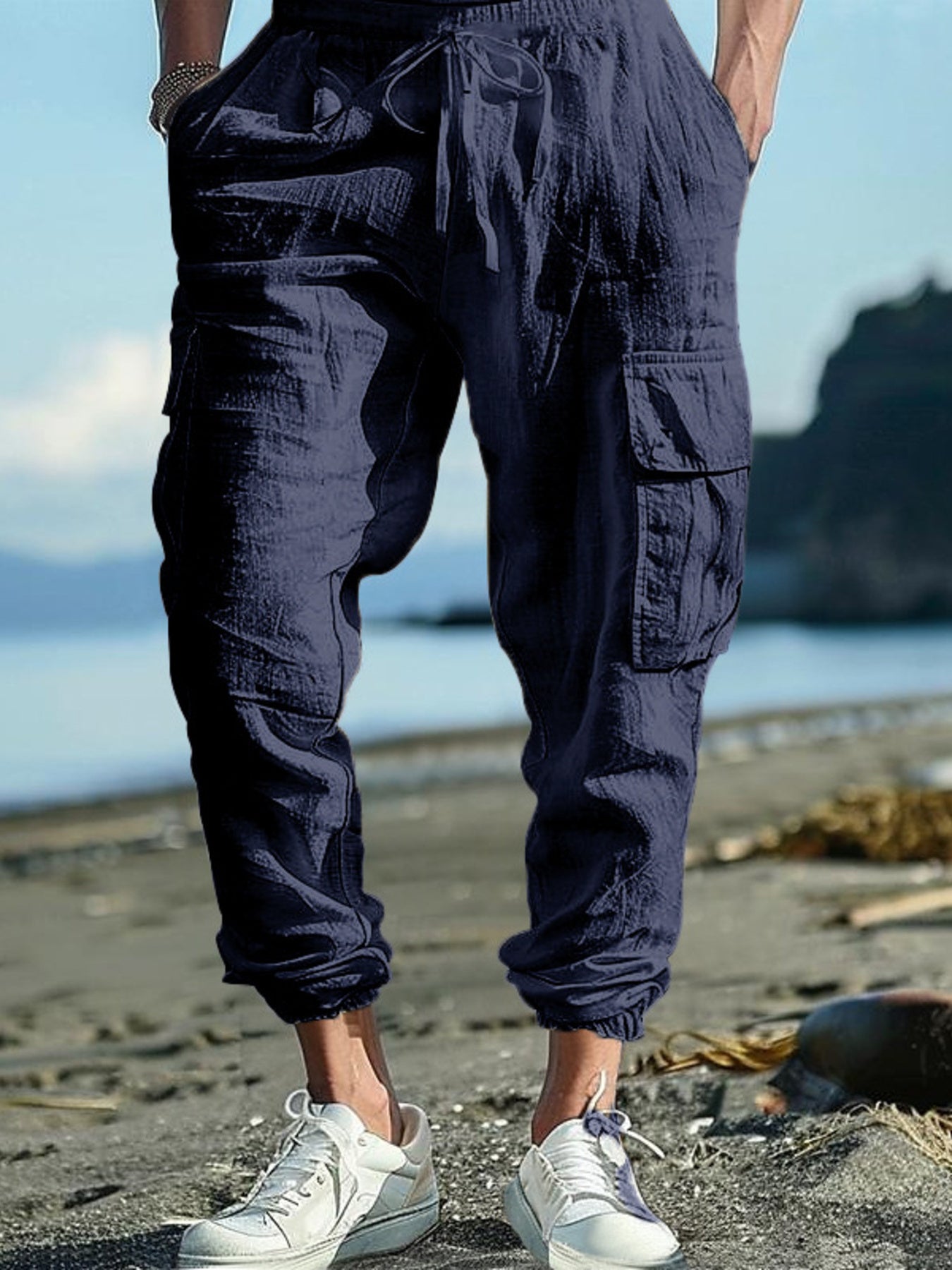 Navy blue cargo pants with drawstring detail and elastic cuffs.
