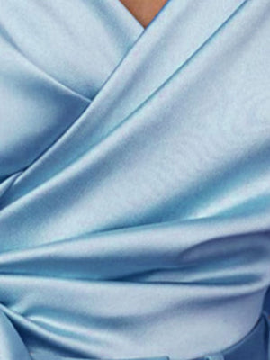 Light blue satin blouse with draped detail and brooch accent