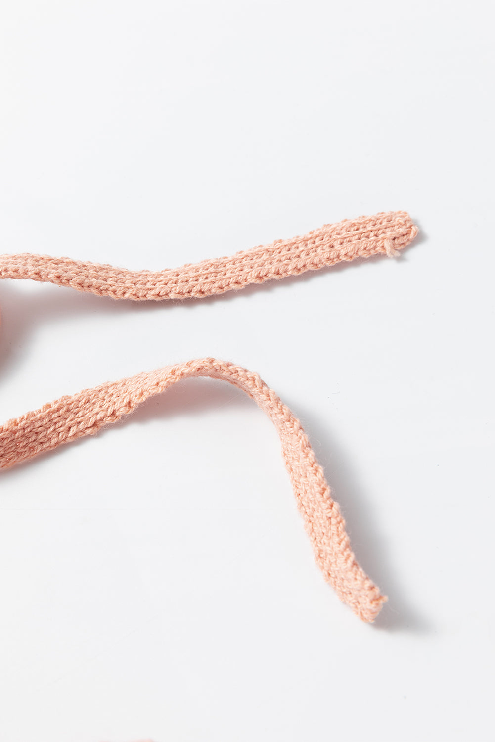 Waffle knit hoodie drawstring detail in peach acrylic.