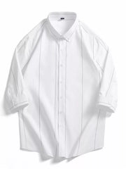 White cotton oversized button-down shirt with subtle grey pinstripes and rolled sleeves.