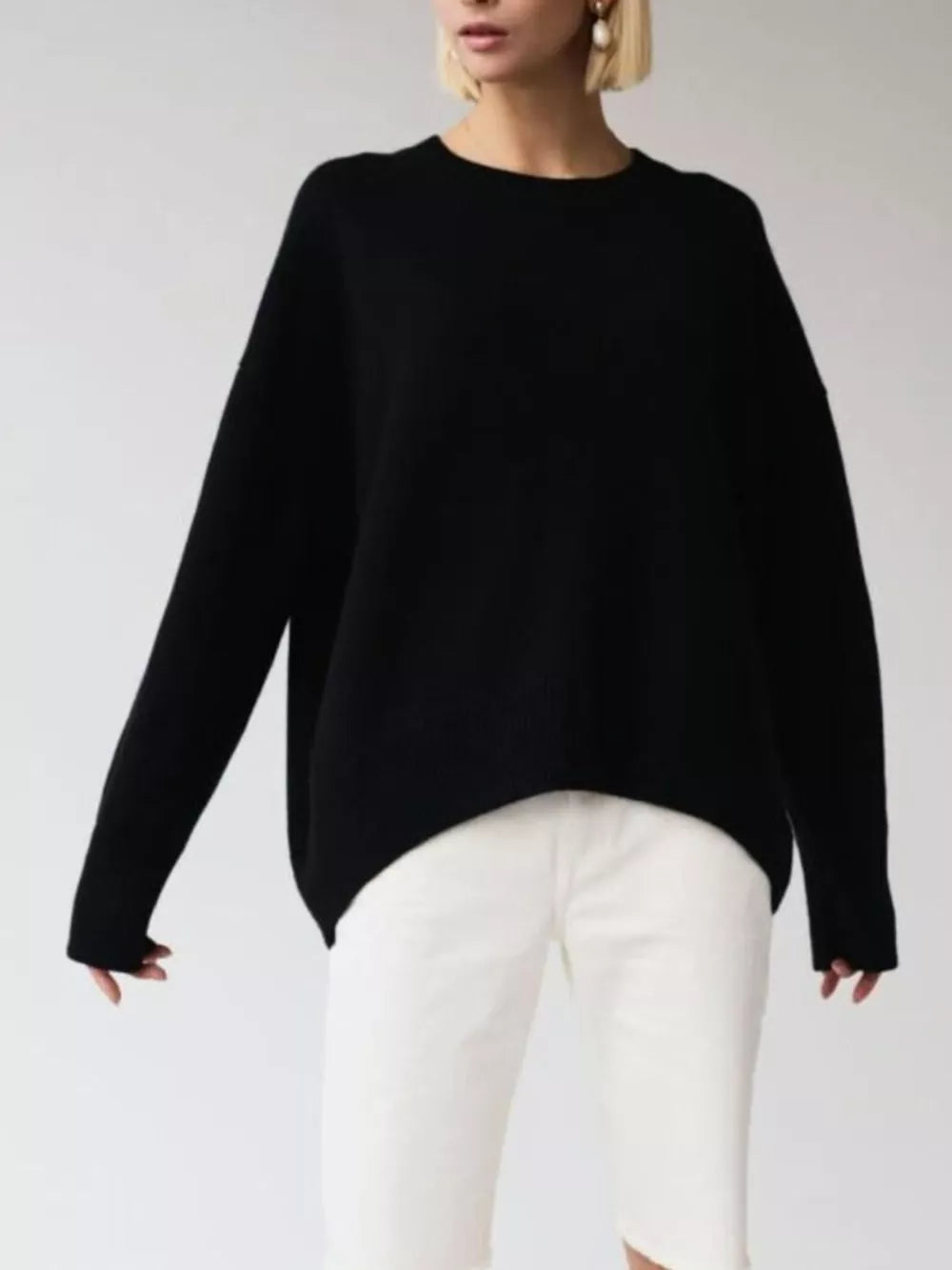 Black soft knit sweater with ribbed detailing, crew neck, long sleeves, and a relaxed fit.