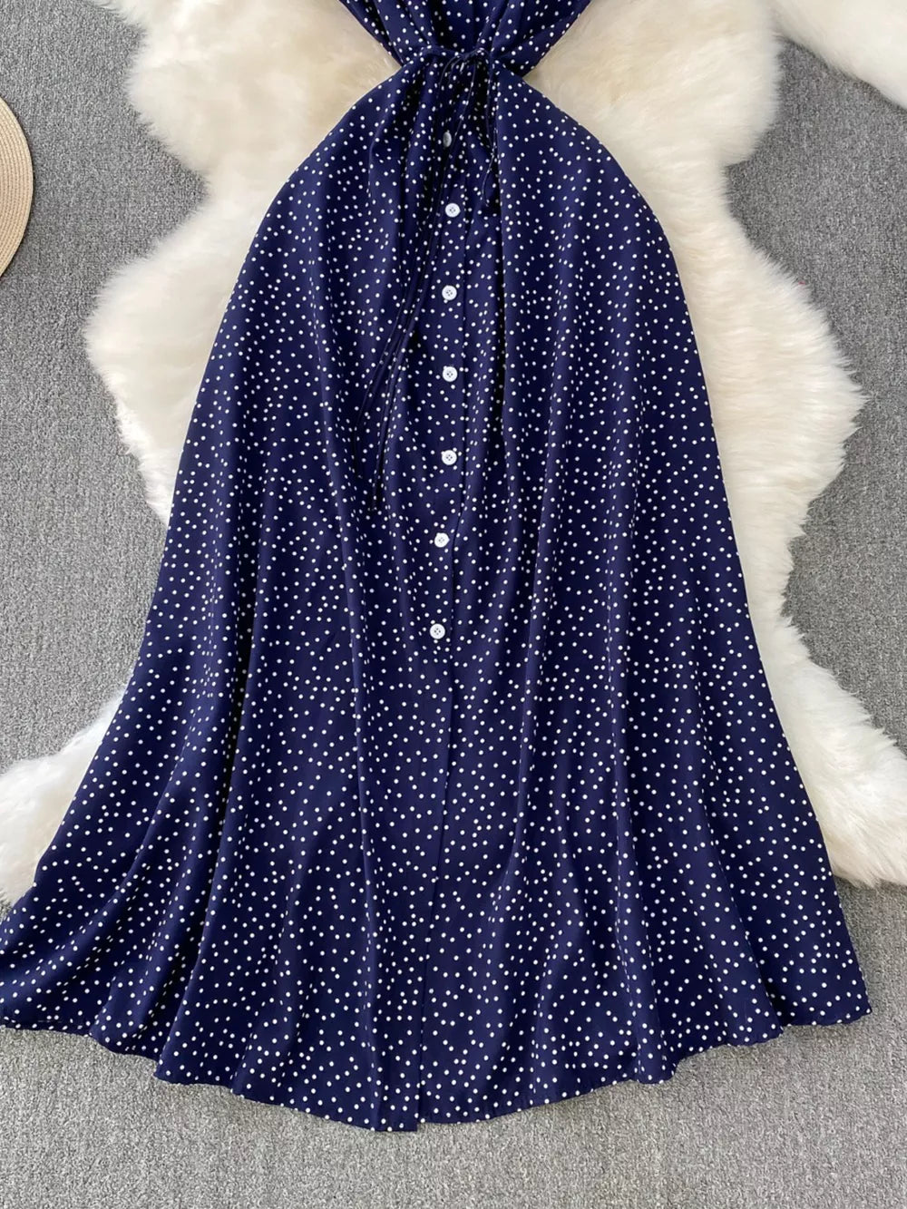 Dark Blue polka dot maxi dress with button front and tie waist detail.