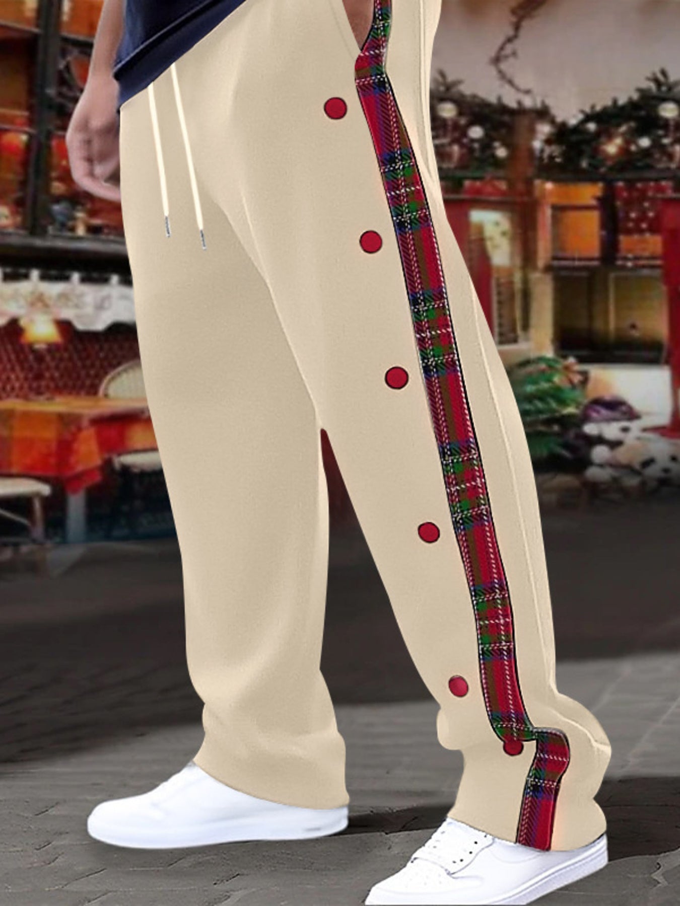 Men's khaki sweatpants with plaid side stripe and snap buttons.