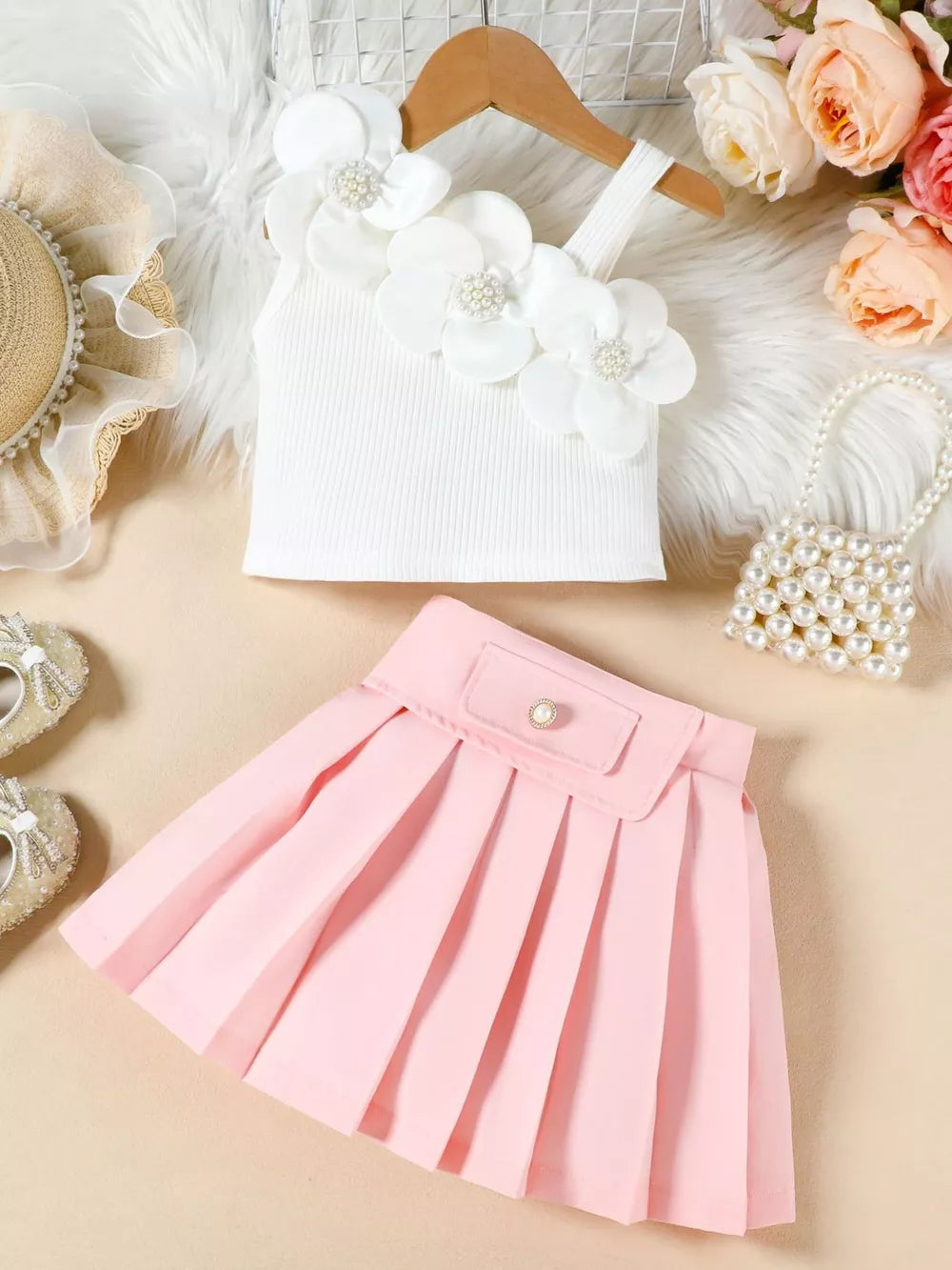 Baby girls' white floral applique tank top and pink pleated skirt outfit.