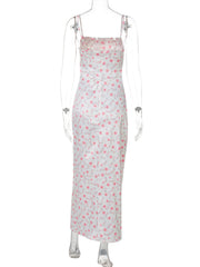White midi dress with pink floral print, spaghetti straps, and square neckline.