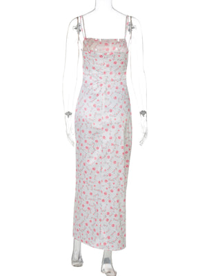 White midi dress with pink floral print, spaghetti straps, and square neckline.