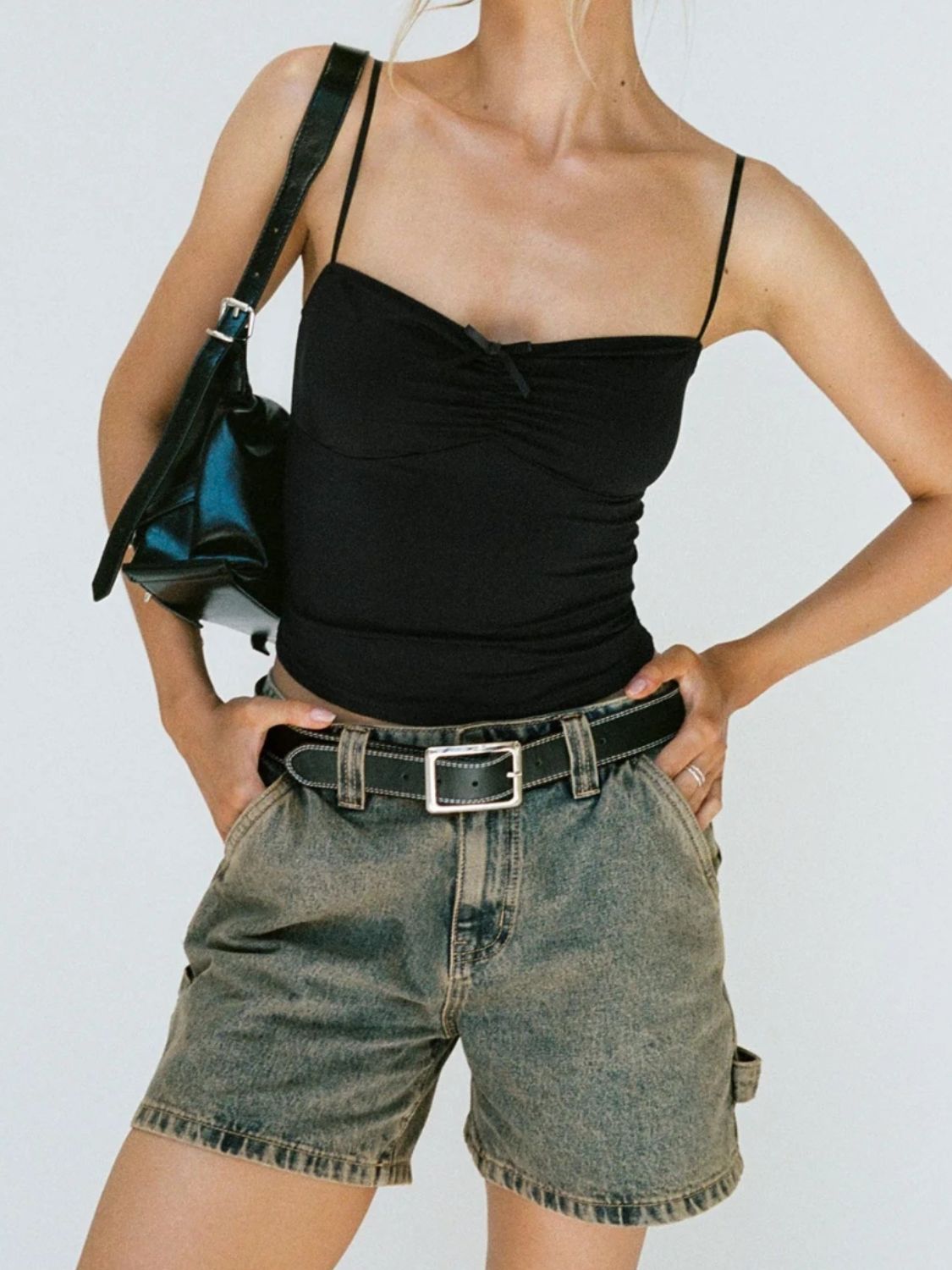 Utility denim carpenter shorts in brass wash with contrast stitching and tool pocket detail.