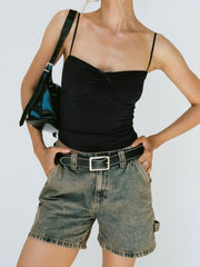 Utility denim carpenter shorts in brass wash with contrast stitching and tool pocket detail.