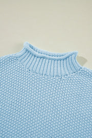 Light blue knit turtleneck sweater with a textured stitch and mock neck detail.
