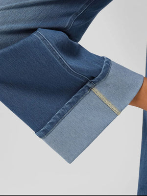 Wide-leg denim jeans in medium wash with a contrasting cuff and visible stitching detail.