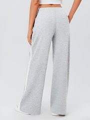 Light gray palazzo trousers with textured fabric and white side panels.