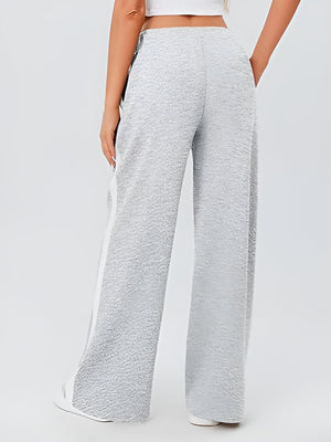 Light gray palazzo trousers with textured fabric and white side panels.