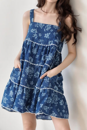 Floral denim sundress with pockets and tiered skirt in medium wash cotton.
