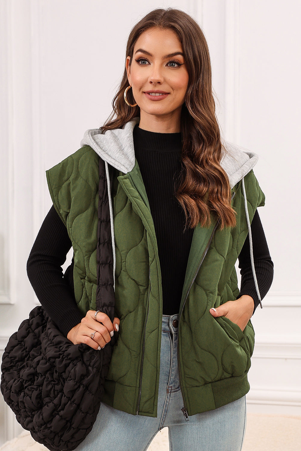 Quilted moss green hooded sleeveless jacket with zipper and pockets