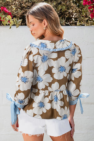 Floral print blouse in camel with Peter Pan collar and tie sleeves.