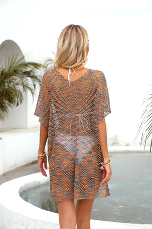 Metallic knit batwing cover-up with V-neck and short sleeves in a multicolor pattern.