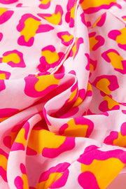 Pink satin pajama set with bold leopard print in hot pink and yellow.