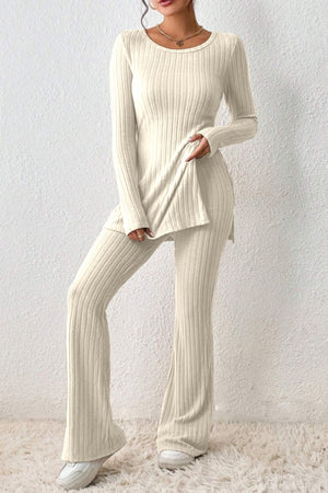 Cream ribbed knit co-ord set with flared pants and side slit tunic.