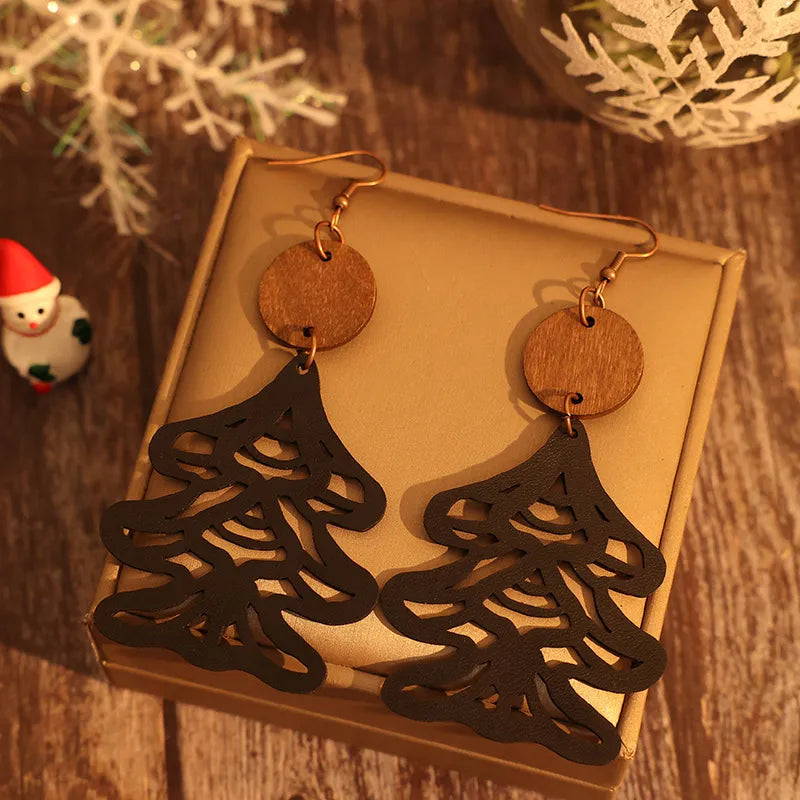 Black laser-cut pine tree earrings with wooden circle tops.