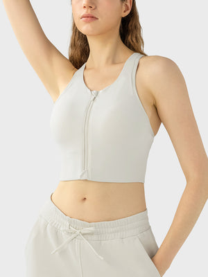 Zip-front racerback sports bra in ivory with a U-neckline and cropped length.