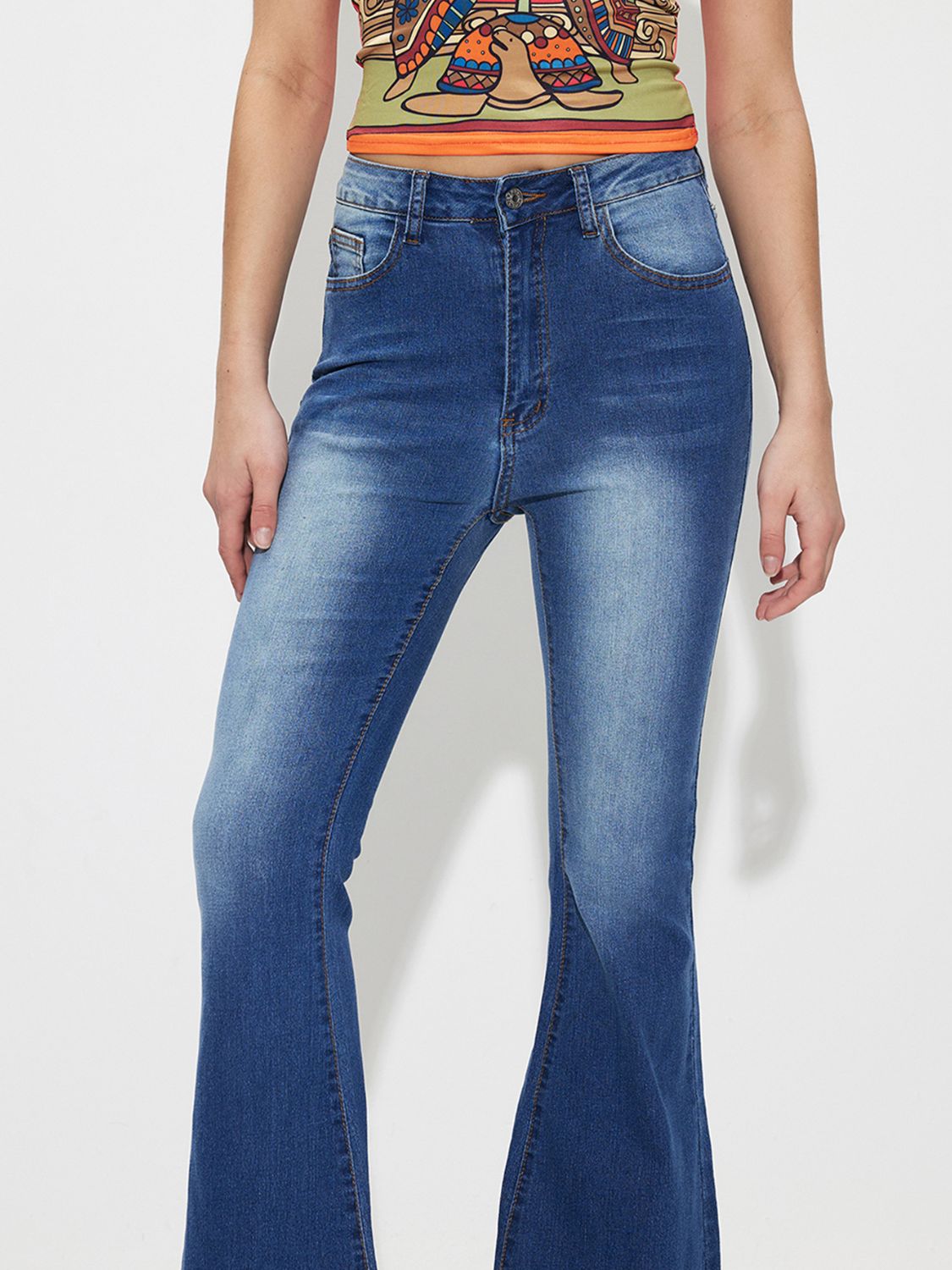 Mid-rise flare jeans in medium wash denim with a buttoned fly.