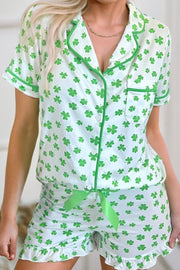 Green shamrock print silk pajama set with short sleeves and shorts.