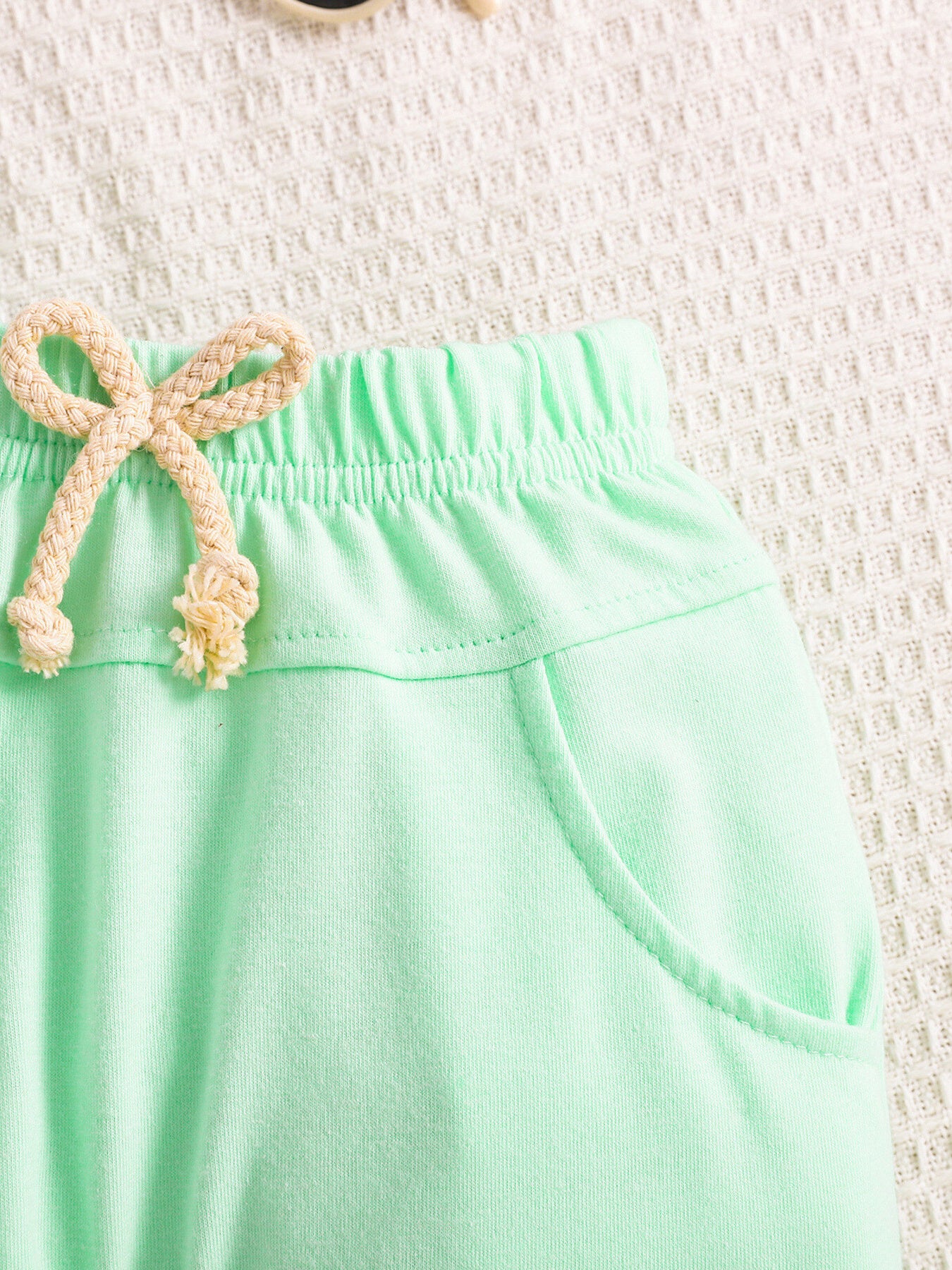 Light green cotton baby shorts with drawstring and pockets
