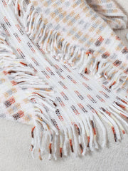 Textured fringe shawl cardigan in white with multicolor woven pattern and fringe details.
