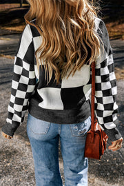 Colorblock checkerboard knit sweater in black and white acrylic with crew neck.