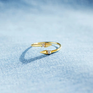 Gold bypass ring with spiked ends and cubic zirconia details