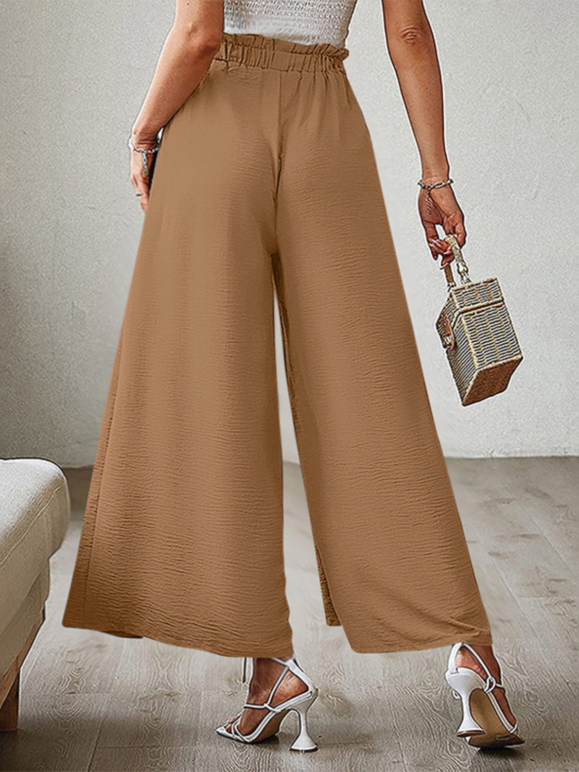 Caramel paperbag waist palazzo pants with side slits and a textured fabric.
