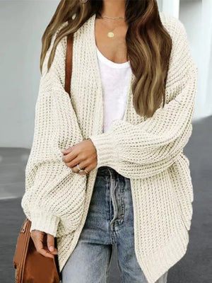 Chunky knit cocoon cardigan in tan with balloon sleeves and an open front, styled with a white tank and jeans.