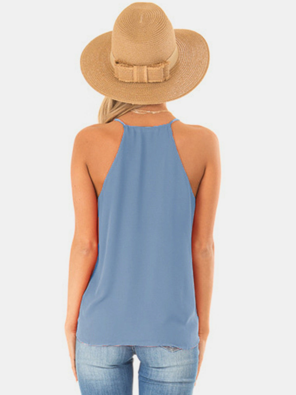 Misty Blue halter cami with crossover neckline and raw hem detail.