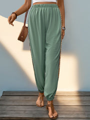 Gum Leaf relaxed-fit joggers with embroidered side trim and elastic waistband.