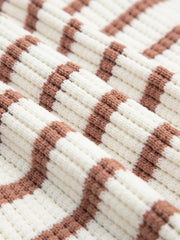 Scalloped-trimmed striped knit top in caramel and cream acrylic with a ribbed texture.