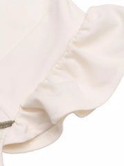Beige maternity jumpsuit with delicate ruffle trim and subtle floral embroidery detail.