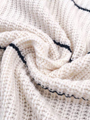 White open knit cardigan with horizontal navy stripes and a textured acrylic weave.